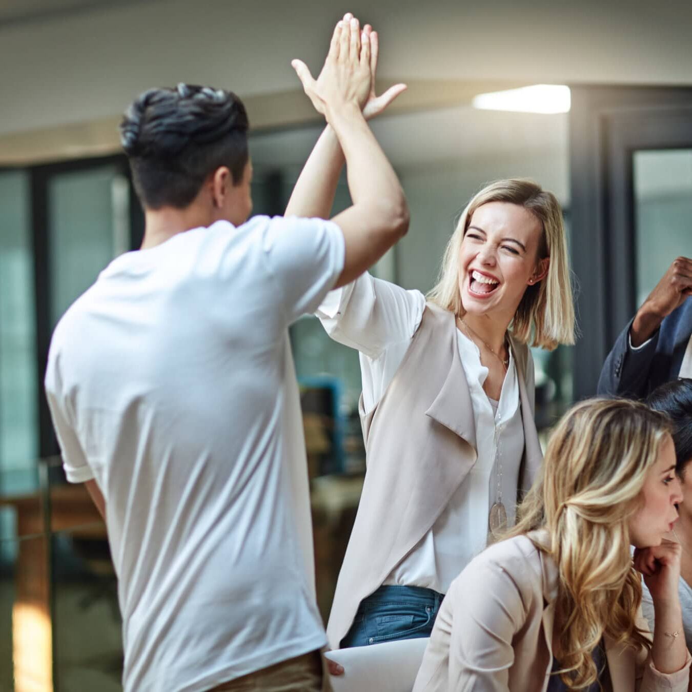 icf-about-ce-ecosystem-networking Two people high five in celebration of the Coach Educators networking