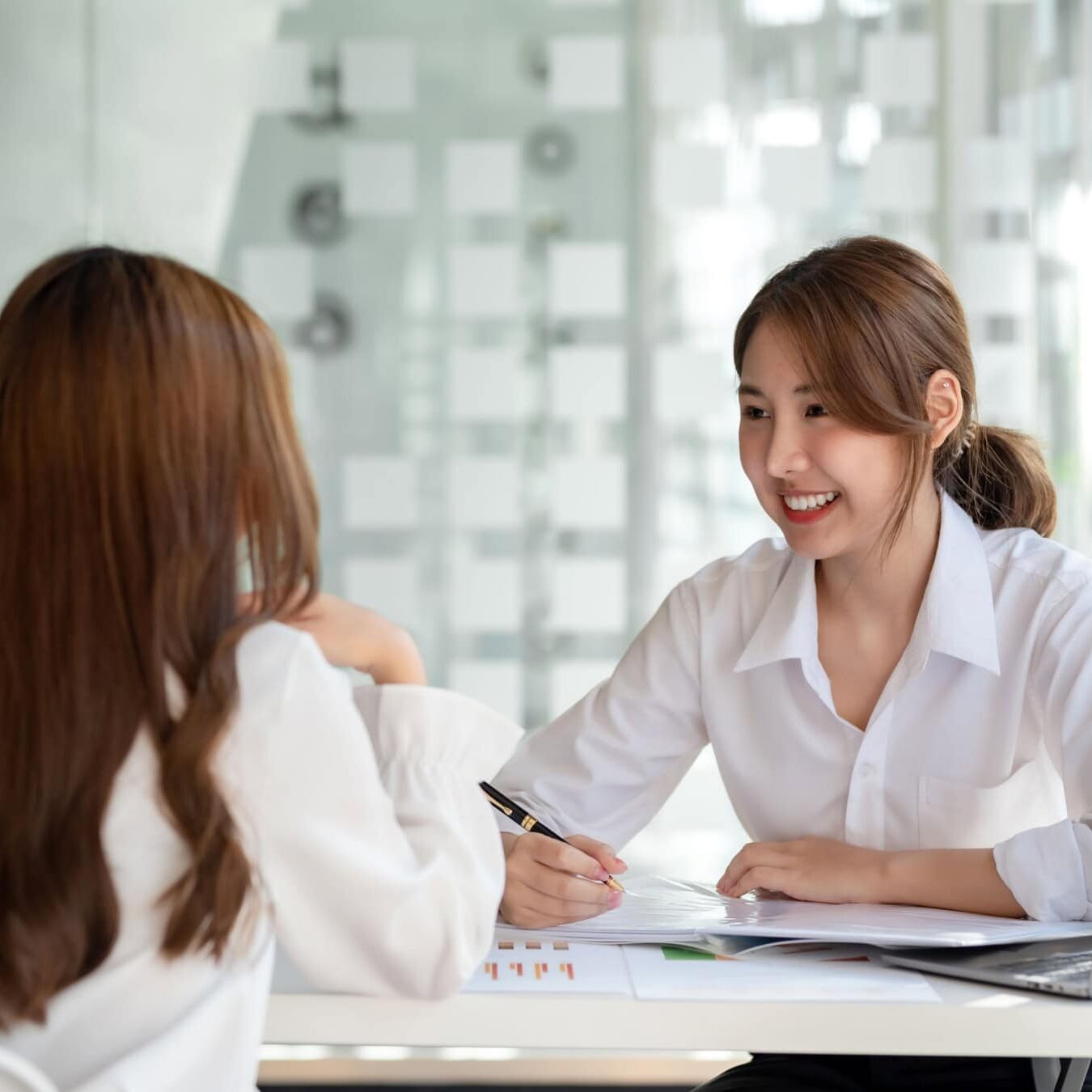 icf-about-coaching-culture-esg Two women go over the latest ESG report from ICF.