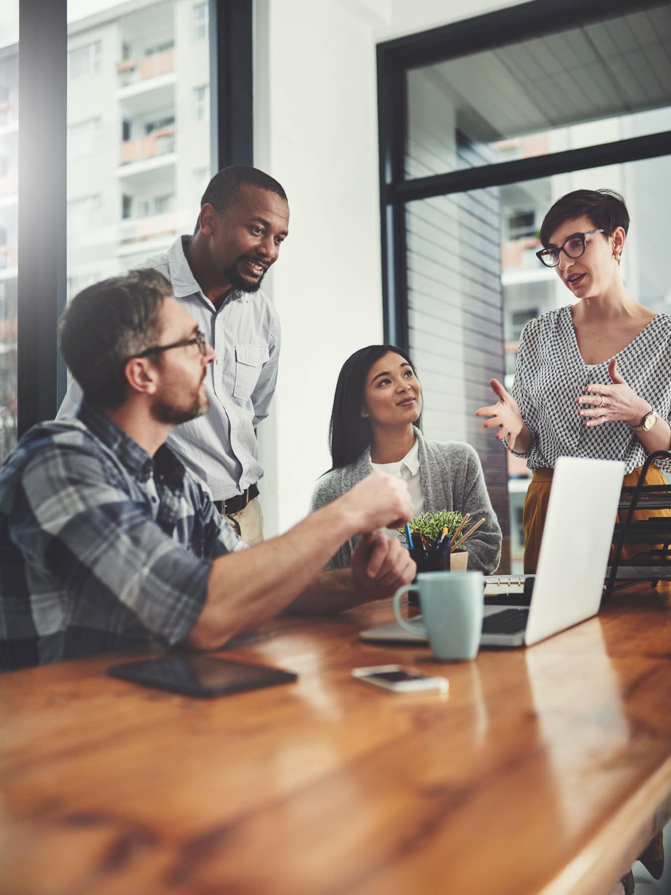 icf-about-coaching-in-organizations A group of professional coaches in an organization gather in an office setting