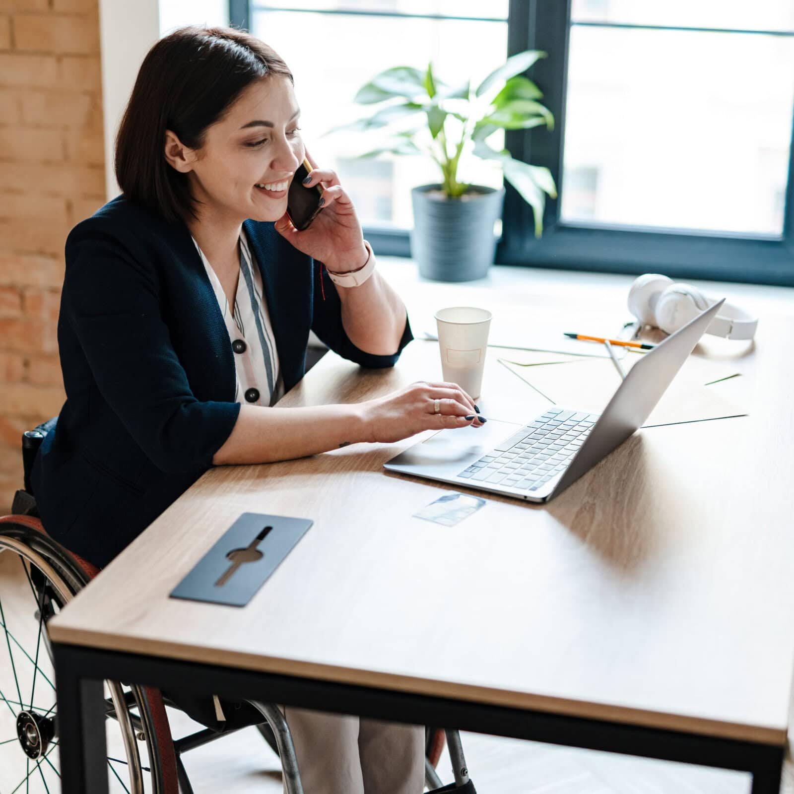 Young,Disabled,Business,Woman,In,Wheelchair,Working,At,Office,Desk Educators creating programs that adhere to ICF accreditation standards