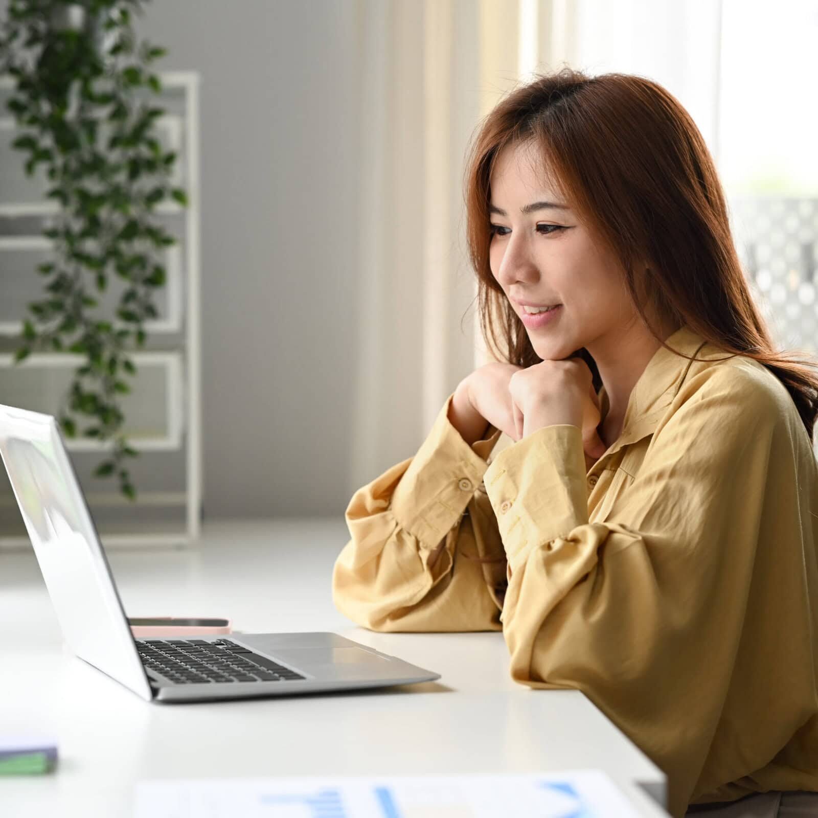Attractive businesswoman making video call to business partner o Coach education providers designing skill-based coaching curriculums
