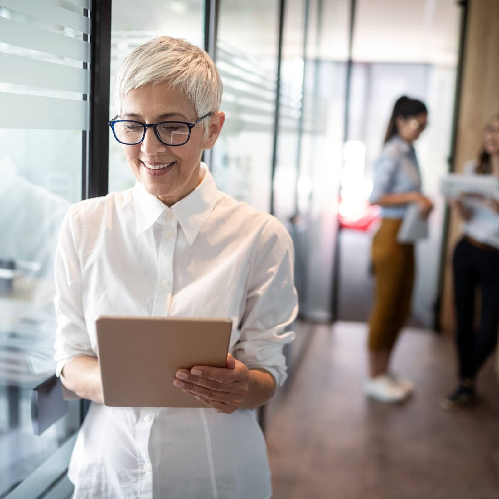 Pretty senior business woman, successful confidence in financial building Program providers working on ICF-approved coach education curriculum.