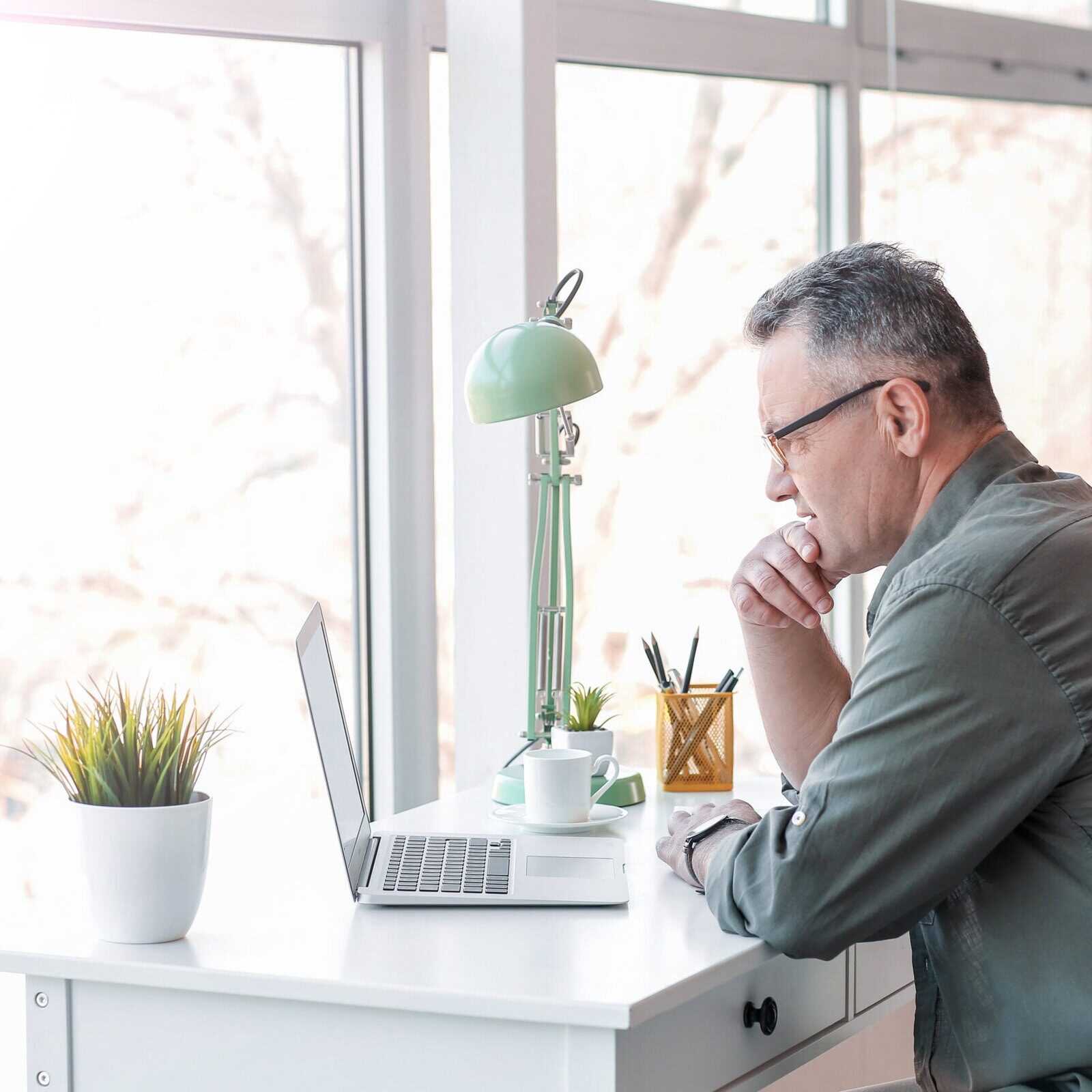 Mature,Man,Using,Laptop,At,Home Coach educators preparing ICF-accredited programs for aspiring coaches