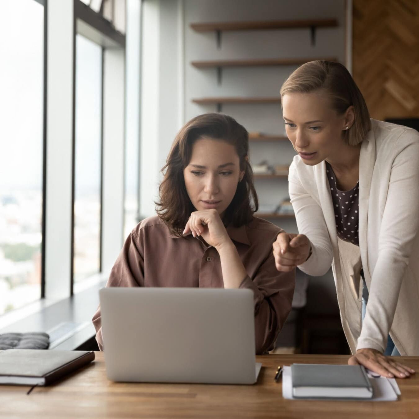 icf-credential-application-paths Two women look at a computer and view the ICF Credential Application paths