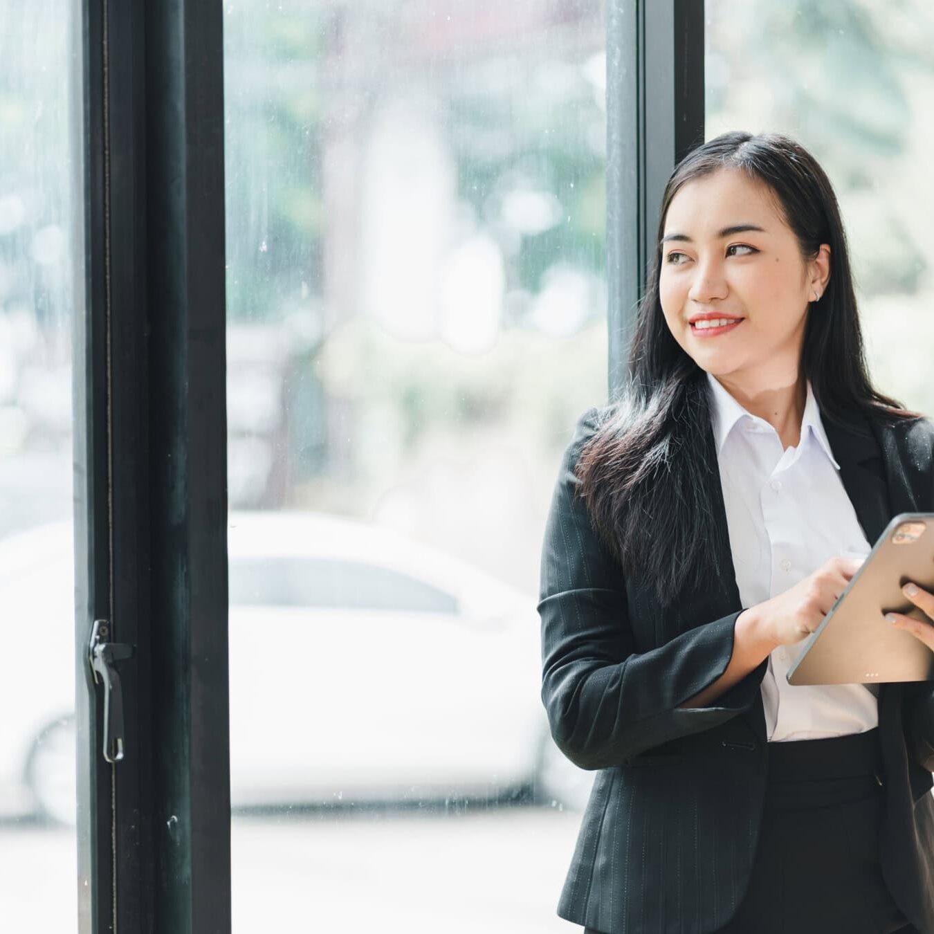 icf-credentialing-acc-exam-next-steps Woman reviews iPad to look at the next steps after taking her ACC Exam