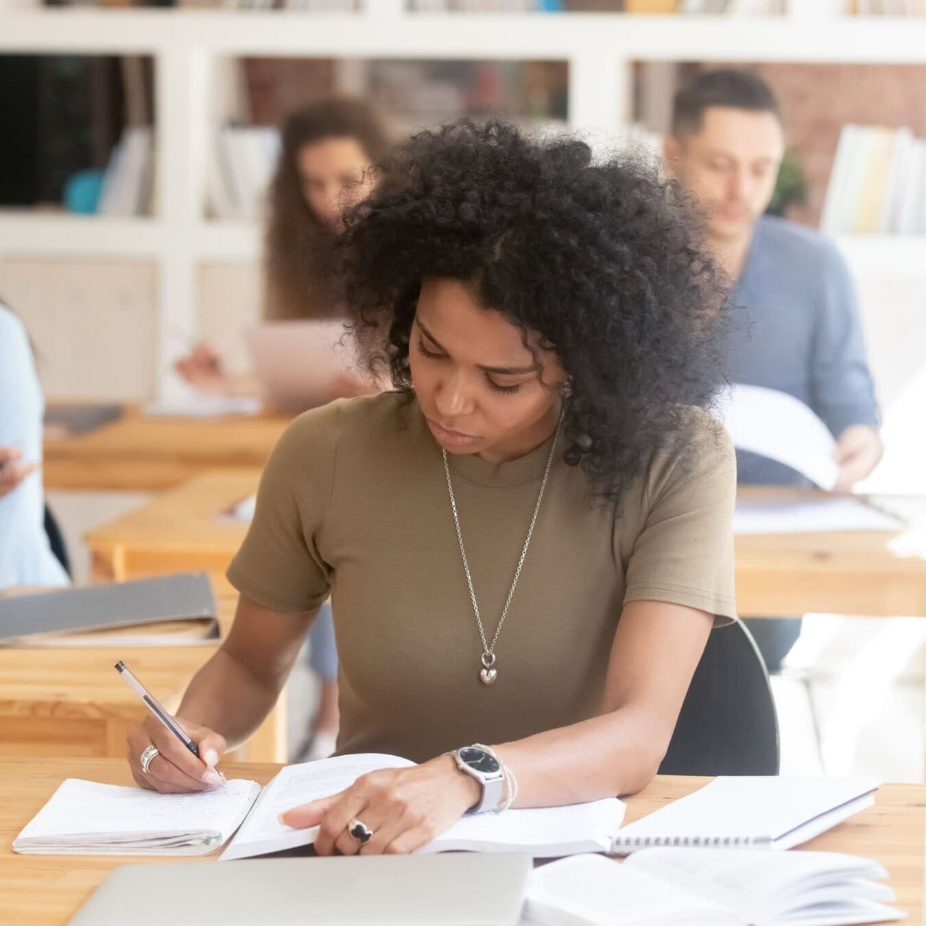 icf-credentialing-accredited-provider-complaints A student is writing notes in her notebook in a classroom