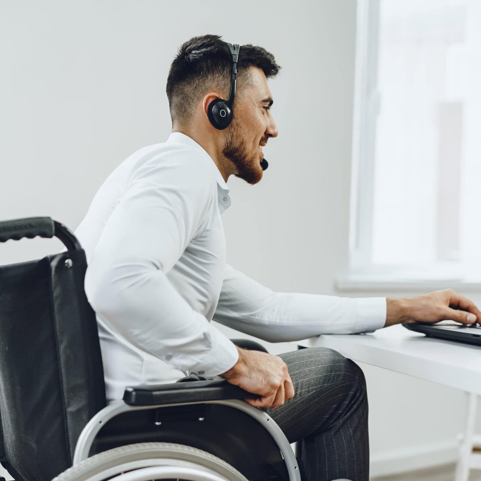 Disabled young man businessman working from home Individual exploring steps to earn ACC, PCC, MCC, or ACTC credentials.