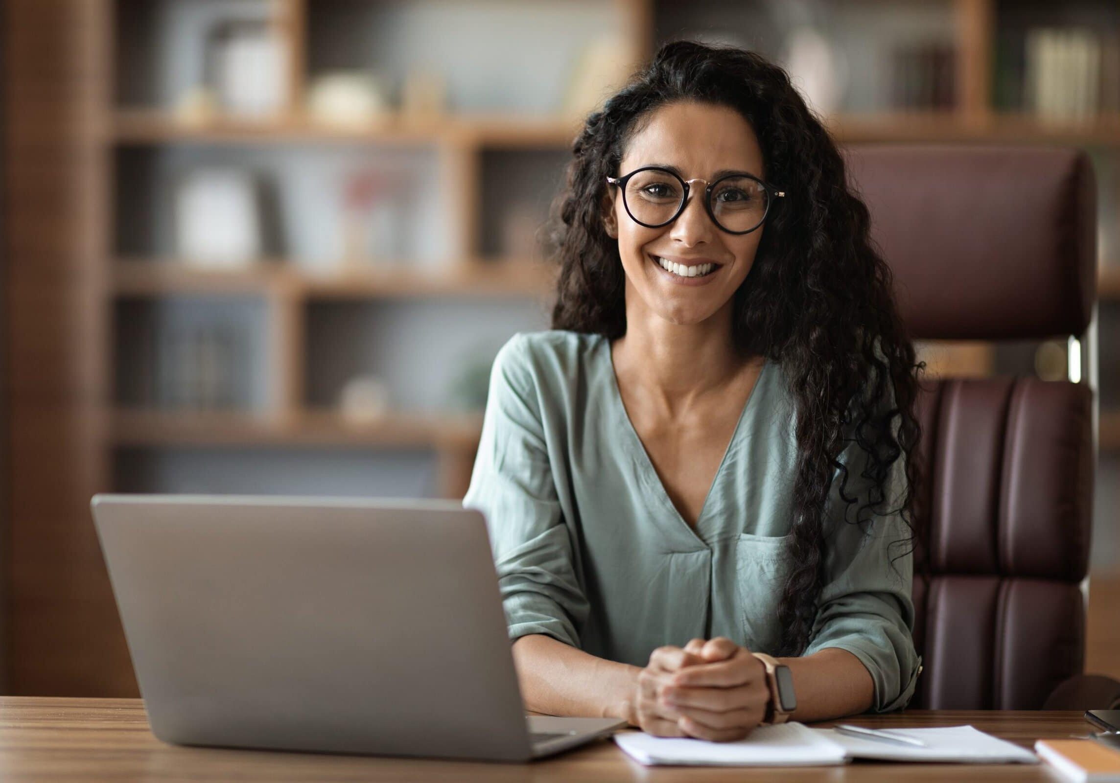 Certified Coach Smiling at Desk Professional Coach has earned their ICF Professional Certified Coach (PCC) Credential