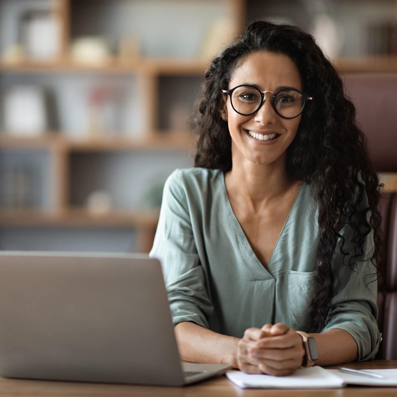 Certified Coach Smiling at Desk Professional Coach has earned their ICF Professional Certified Coach (PCC) Credential