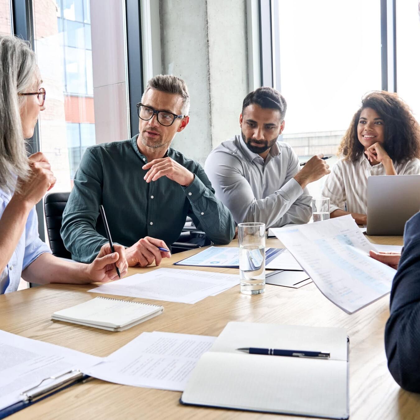 icf-credentialing-development-acc-exam A group of people work together in an office setting at a table