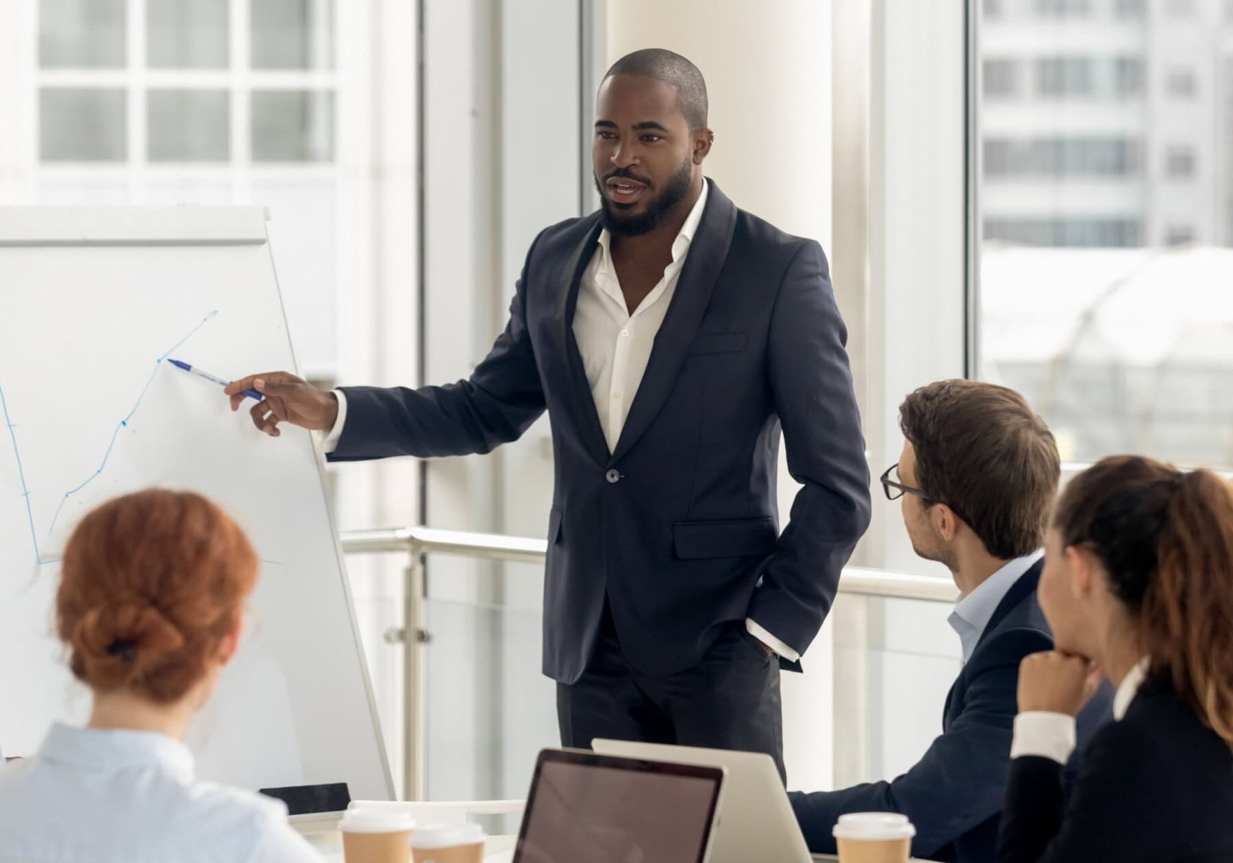 icf-credentialing-ehtical-process A man explains the ethical complaint process to a group of people in an office.