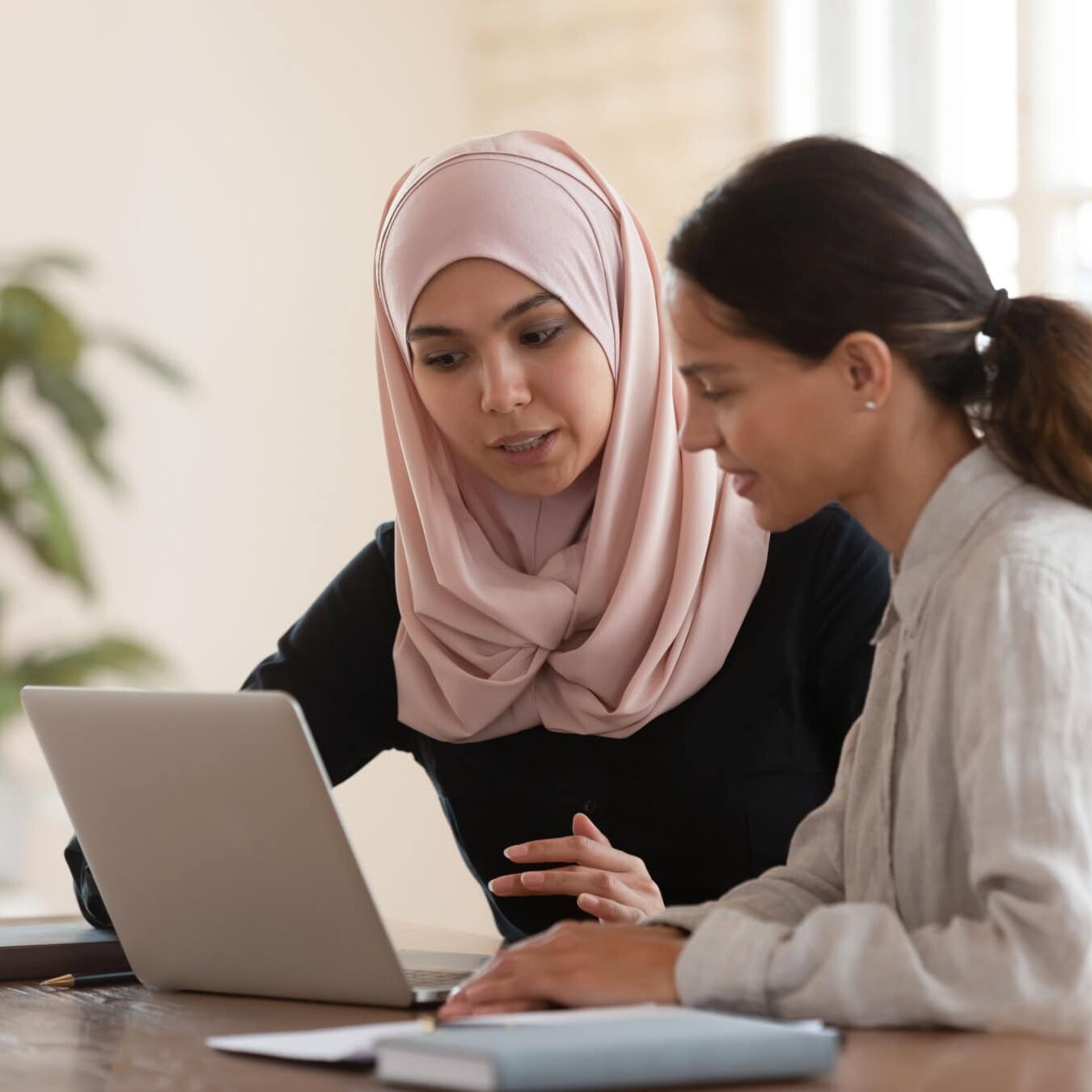 icf-credentialing-eligibility-coaching-clients Two woman review the ICF coaching situations to determine eligibility