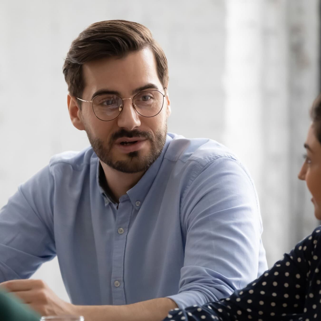icf-credentialing-ethical-coaching-consumer-complaint A man is talking with another woman in an office setting diving into coaching consumer complaints