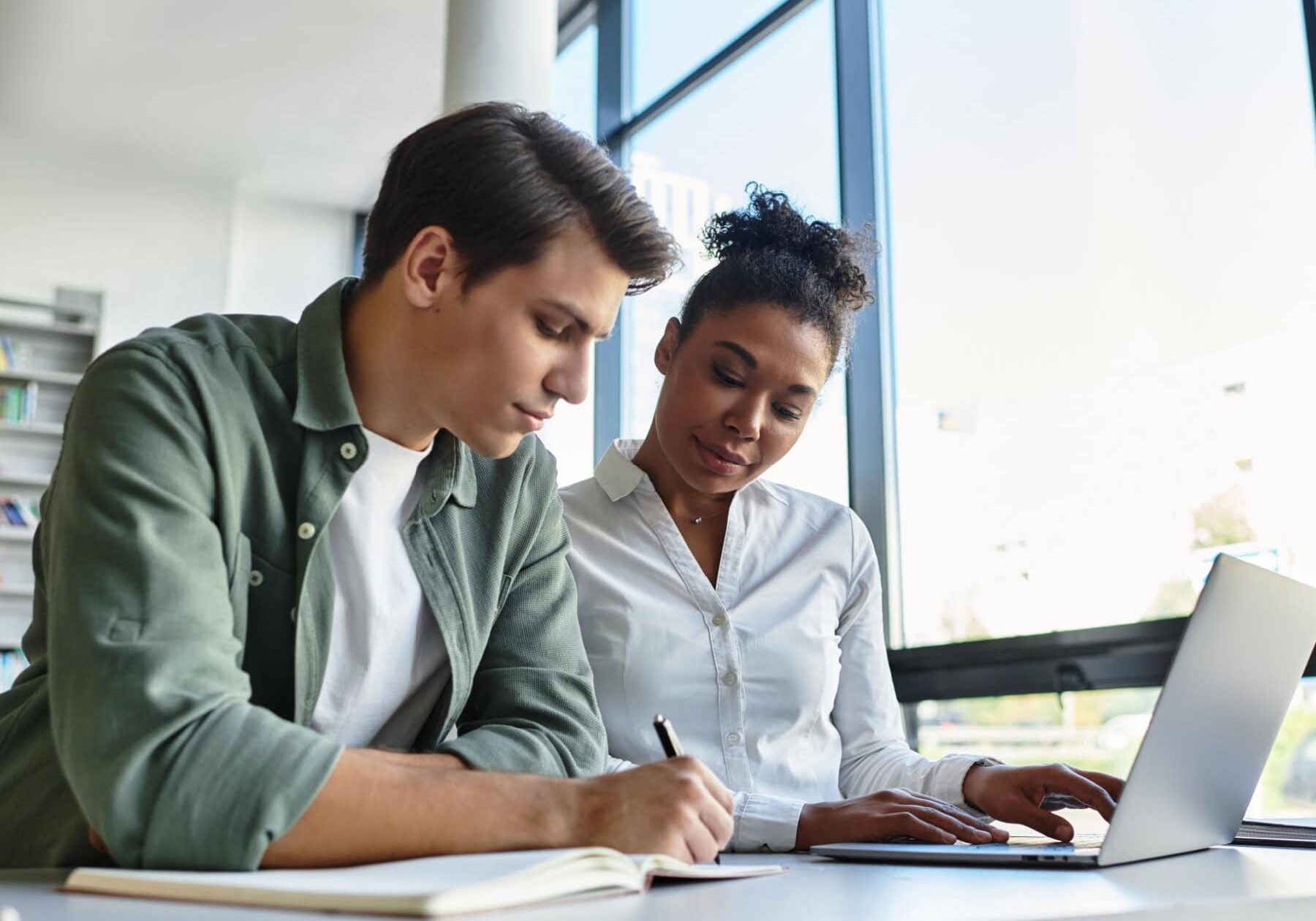 icf-credentialing-file-a-complaint A woman is showing a man on a laptop how to file an ethical complaint