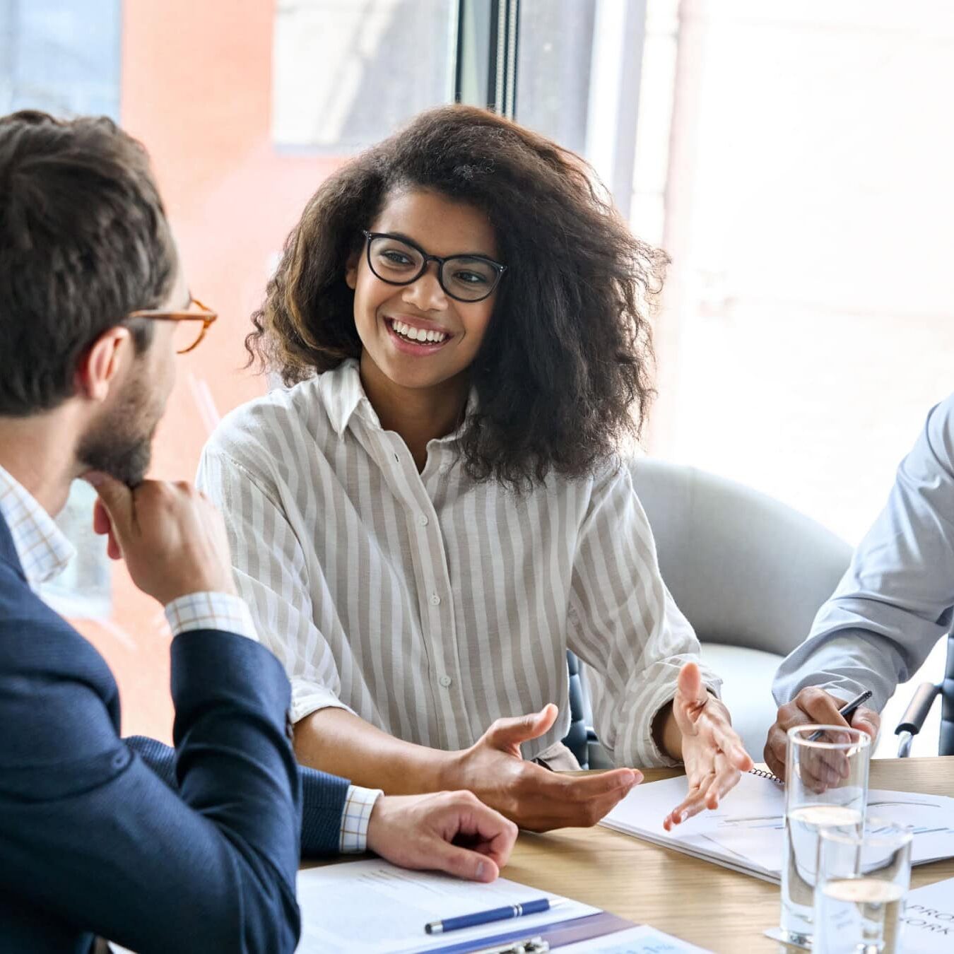 icf-credentialing-icf-credential-exam-next-steps A group of professional coaches work together in an office to determine next steps