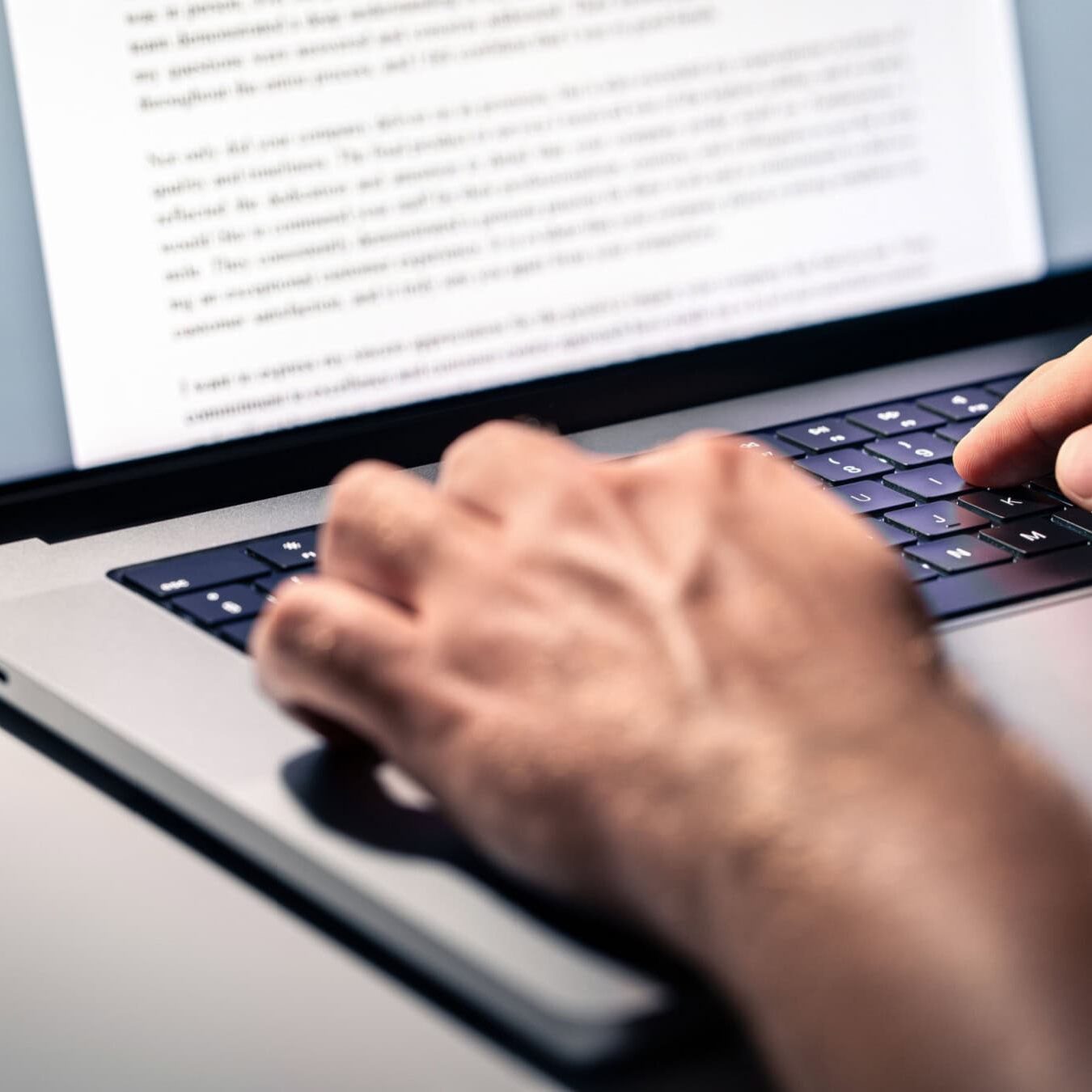 icf-key-research-findings A person types up the key findings of a research report onto a laptop