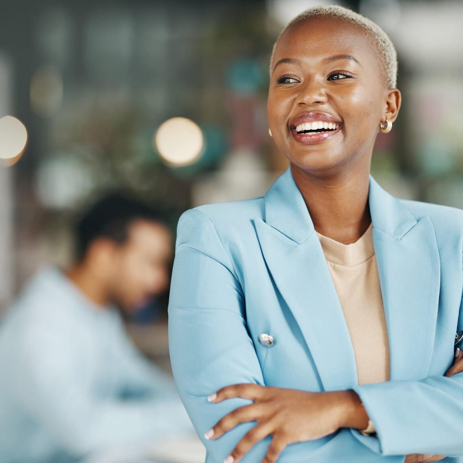 Happy,,Smile,And,Arms,Crossed,With,Black,Woman,In,Office smiling woman with arms crossed and blurred office behind her